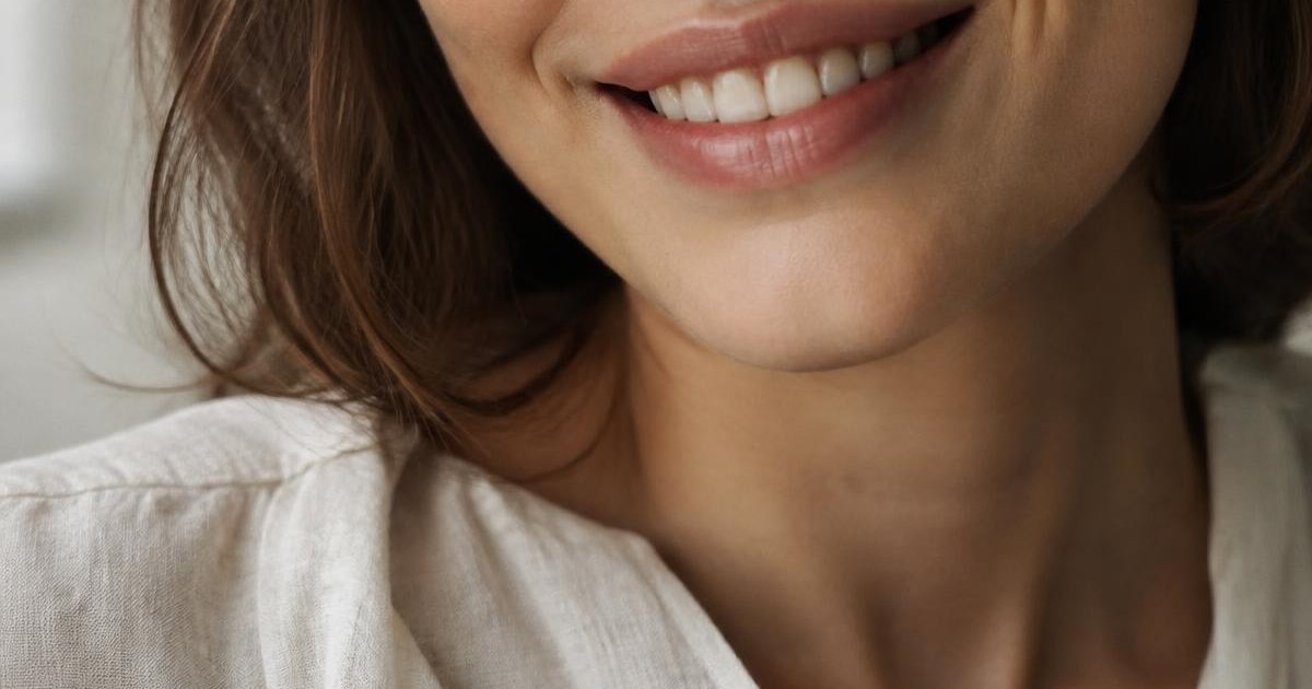 Illustrative editorial photograph of a natural relaxed smile